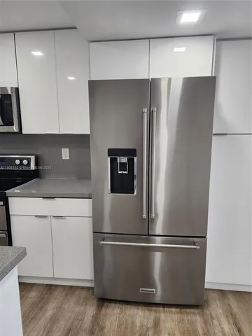 a refrigerator freezer sitting in a kitchen