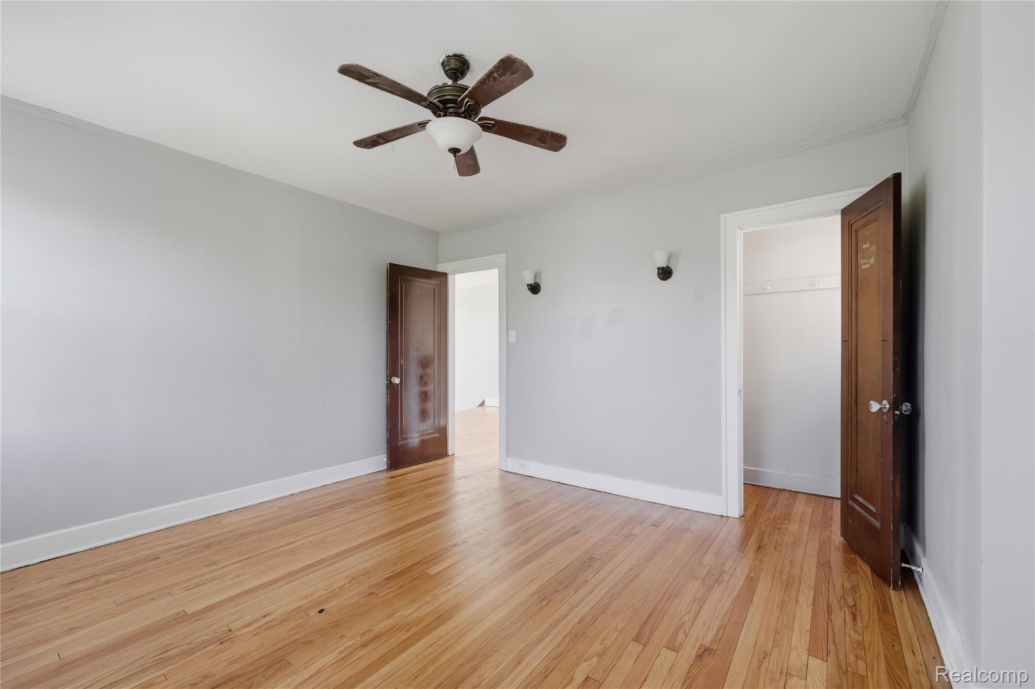 1945 Atkinson Street Detroit, MI 48206 - Photo 27 of 49 Bright room featuring wood-finish flooring, a ceiling fan with integrated lighting, and light gray wall paint