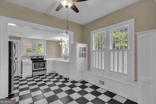 a kitchen with granite countertop stainless steel appliances a stove a sink and a refrigerator