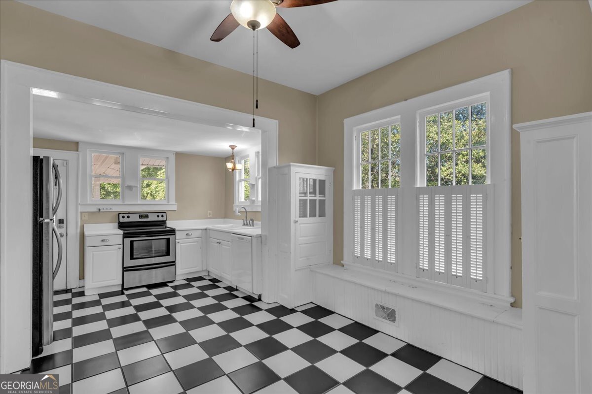 218 West Drive Dublin, GA 31021 - Photo 12 of 49 a kitchen with granite countertop stainless steel appliances a stove a sink and a refrigerator