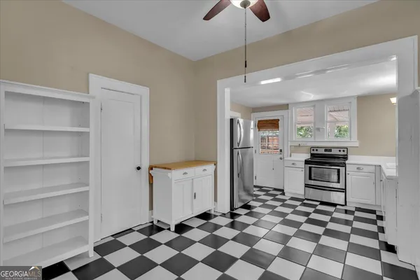 a kitchen with a checkered floor and a refrigerator