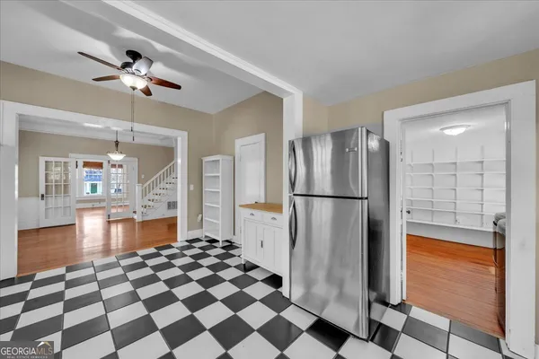 a kitchen with a checkered floor and a refrigerator