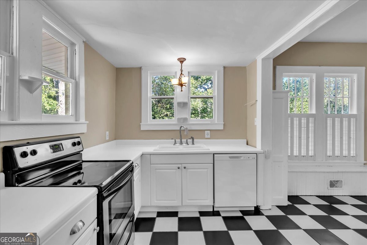 218 West Drive Dublin, GA 31021 - Photo 17 of 49 a kitchen with a stove a sink and a window