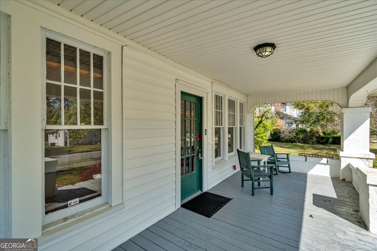 218 West Drive Dublin, GA 31021 - Photo 2 of 49 a view of a patio with table and chairs floor to ceiling window with wooden floor