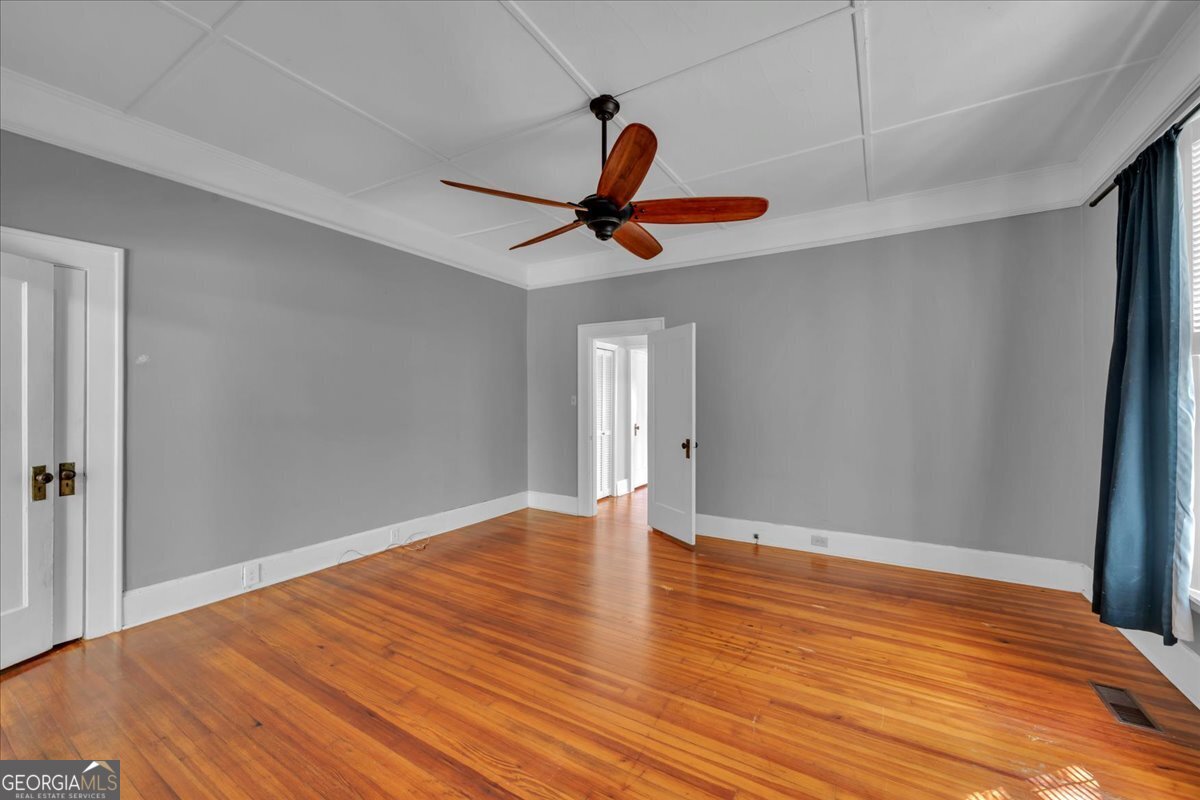218 West Drive Dublin, GA 31021 - Photo 22 of 49 a view of room with wooden floor and ceiling fan