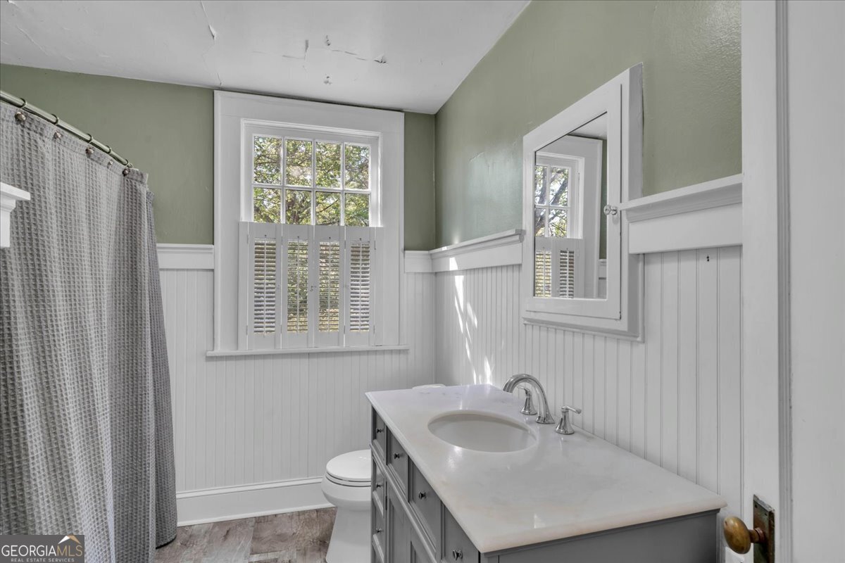 218 West Drive Dublin, GA 31021 - Photo 24 of 49 a bathroom with a sink toilet a mirror and window