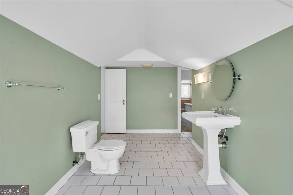 218 West Drive Dublin, GA 31021 - Photo 30 of 49 a bathroom with a sink a toilet and a mirror