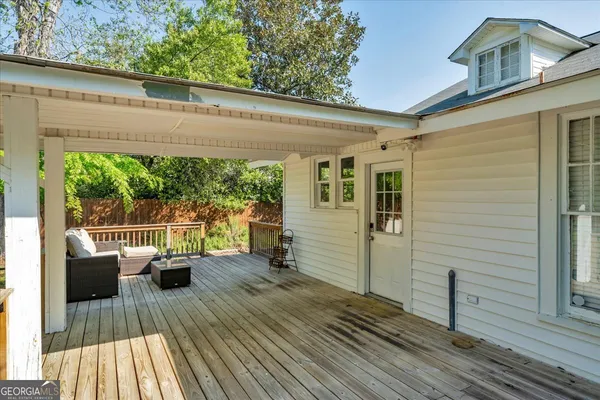 a view of balcony with couch and wooden floor
