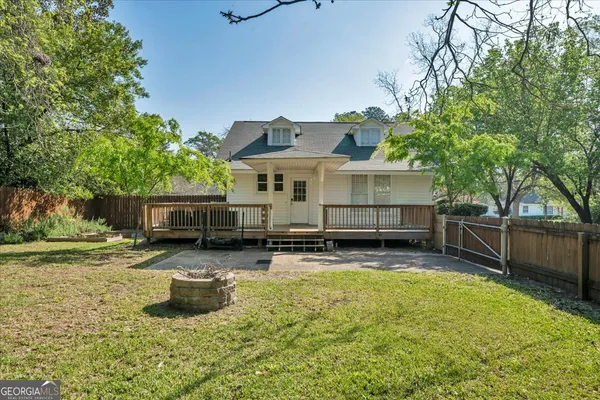 a view of a house with swimming pool and sitting area