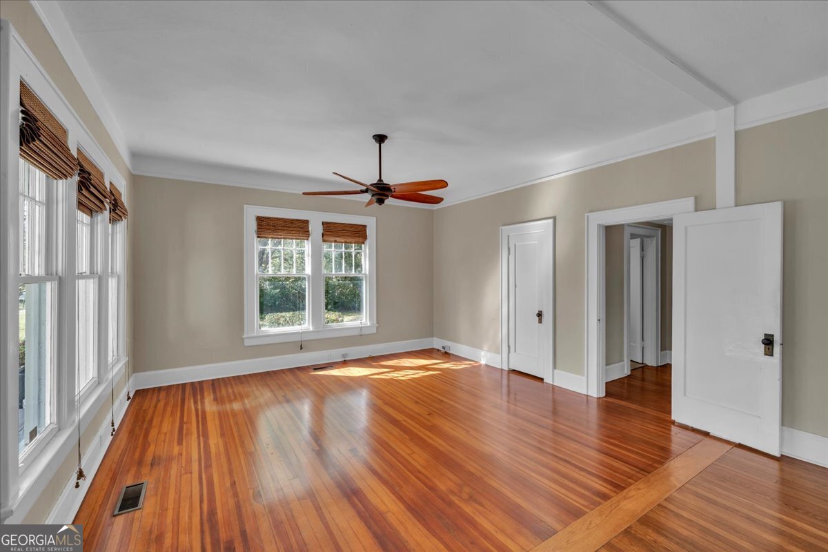 218 West Drive Dublin, GA 31021 - Photo 5 of 49 a view of an empty room with wooden floor and a window