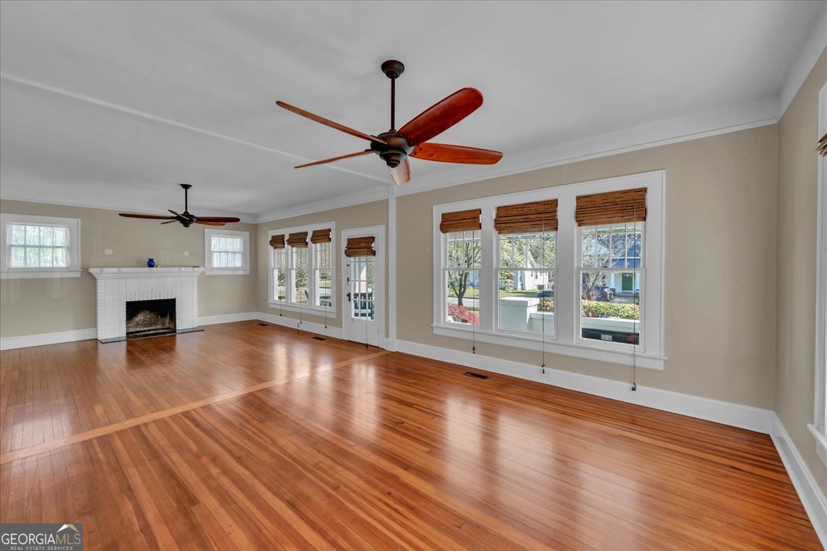 218 West Drive Dublin, GA 31021 - Photo 6 of 49 a view of an empty room with wooden floor and a window