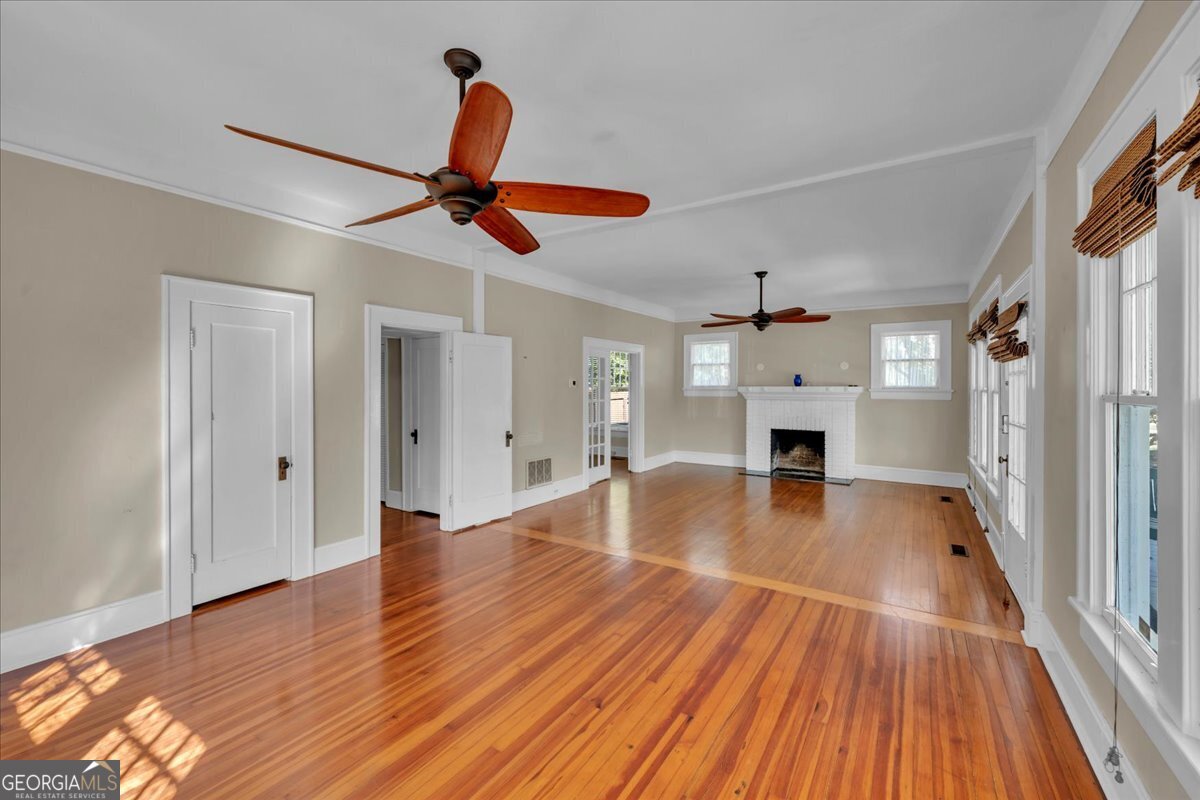 218 West Drive Dublin, GA 31021 - Photo 7 of 49 a view of empty room with wooden floor and fan