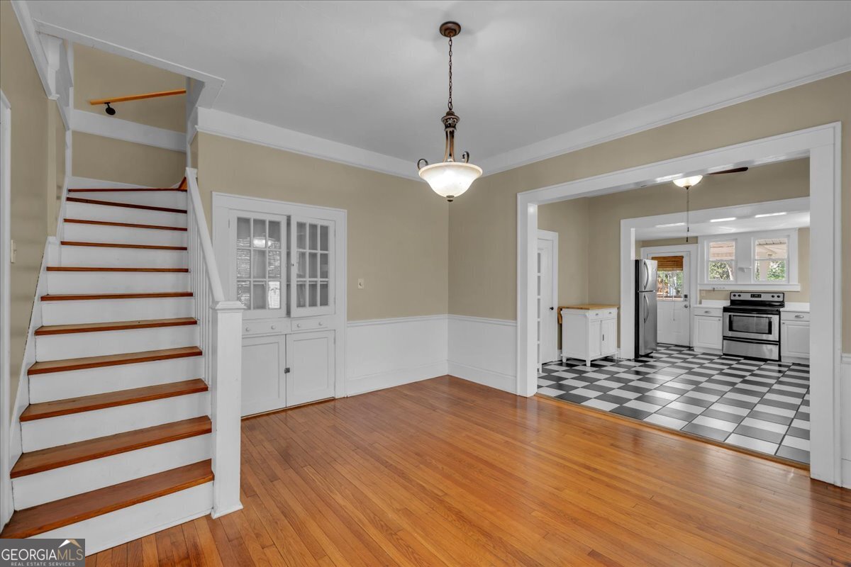 218 West Drive Dublin, GA 31021 - Photo 10 of 49 a view of a kitchen with wooden floor and a ceiling fan
