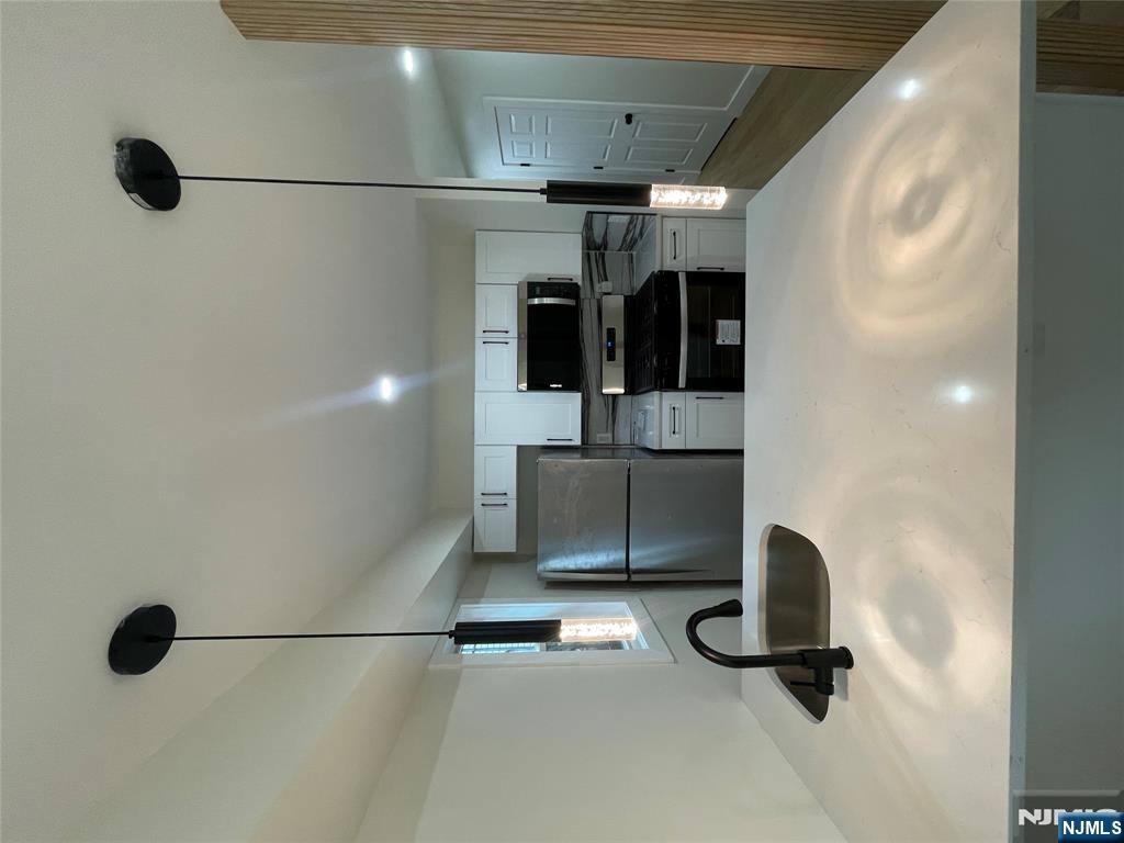 399 18th Avenue, Unit 1 Newark, NJ 07108 - Photo 4 of 9 a kitchen with refrigerator and a sink