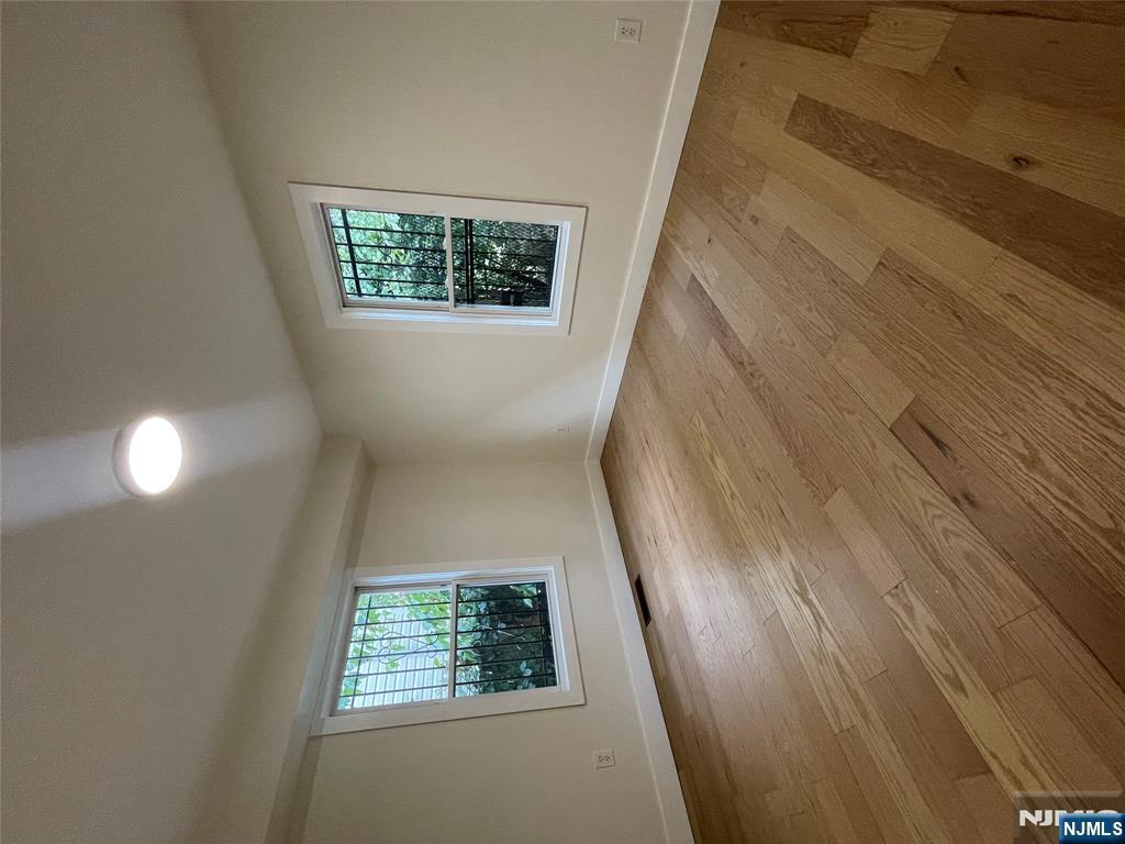 399 18th Avenue, Unit 1 Newark, NJ 07108 - Photo 8 of 9 an empty room with wooden floor and windows