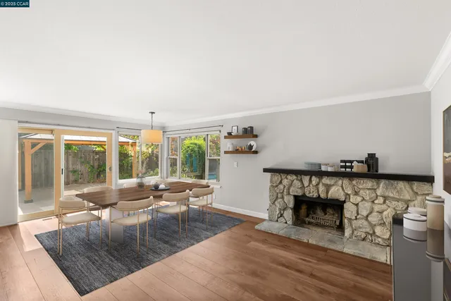 an empty room with windows and fireplace