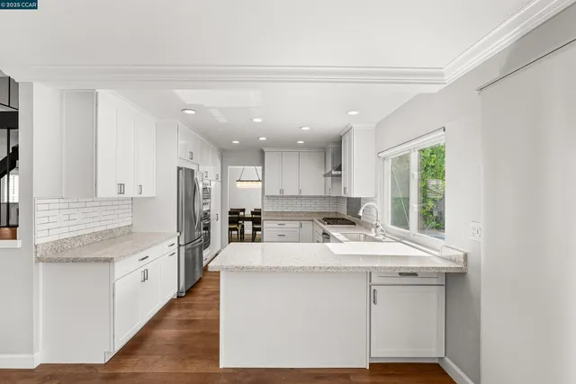 a kitchen with granite countertop a sink cabinets and window