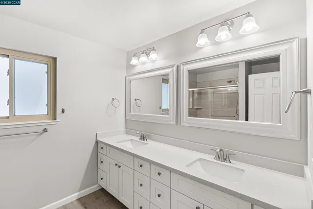 a view of an empty room with chandelier fan and fire place