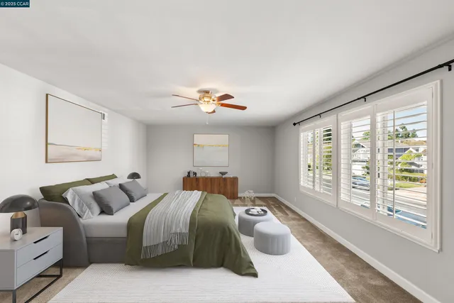 a spacious bedroom with a bed and a large window