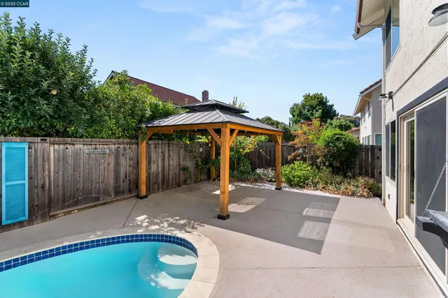 an aerial view of residential houses with outdoor space and trees