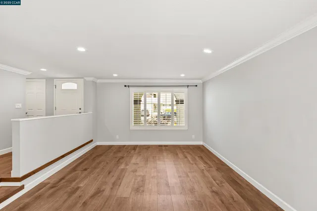 a living room with furniture potted plant and a flat screen tv