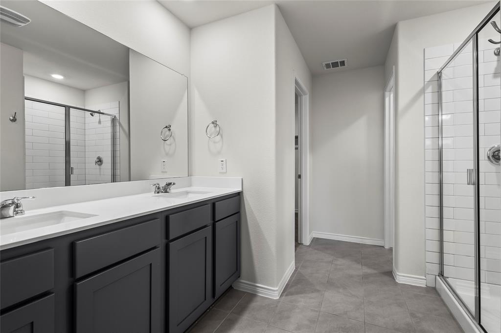 812 Indigo Road Princeton, TX 75407 - Photo 18 of 25 a bathroom with a double vanity sink mirror and double