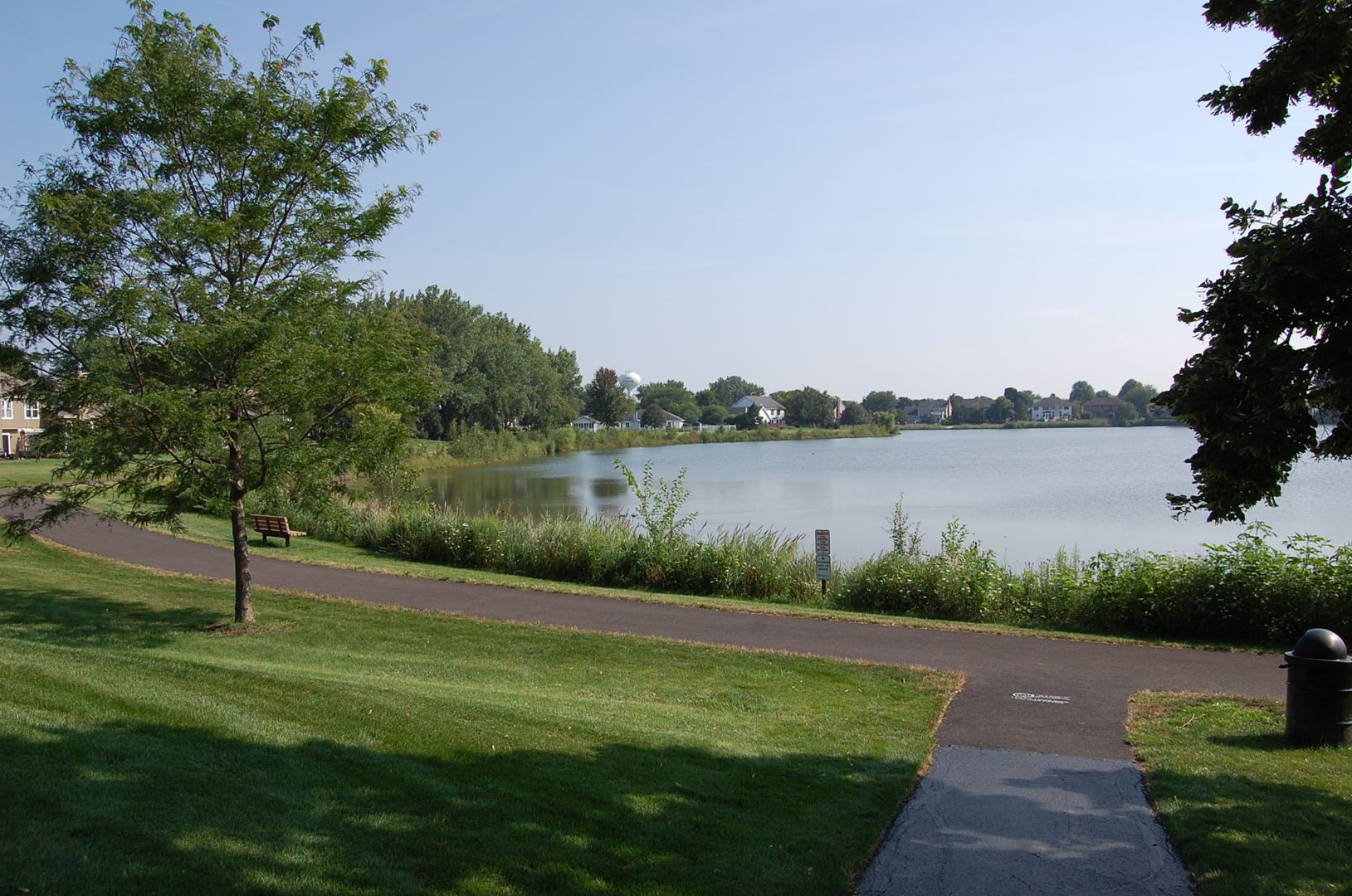 1043 Ridgefield Circle Carol Stream, IL 60188 - Photo 32 of 40 a view of a lake with a yard and large trees