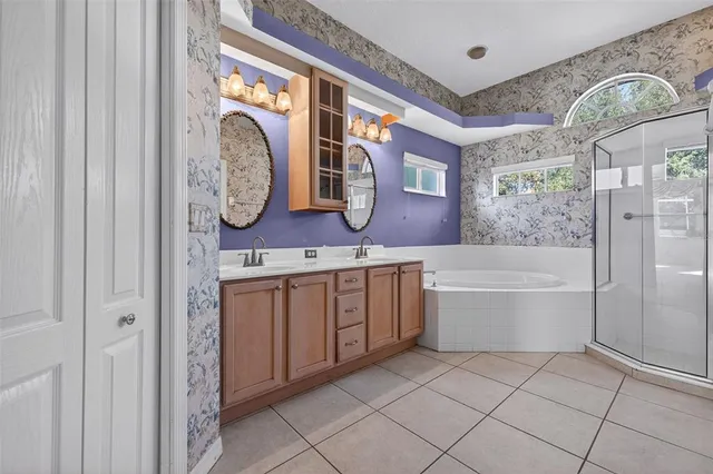 a bathroom with a bathtub sink and mirror