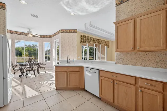 a kitchen with cabinets and chairs
