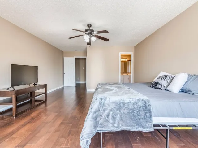 a bedroom with a bed and a chandelier