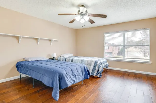a bedroom with bed and window