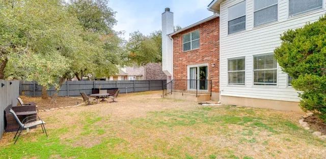 a swimming pool with outdoor seating and yard