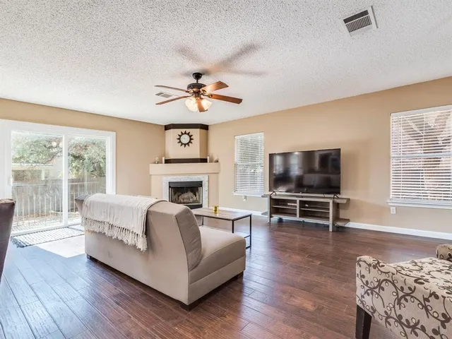 a living room with furniture a fireplace and a flat screen tv
