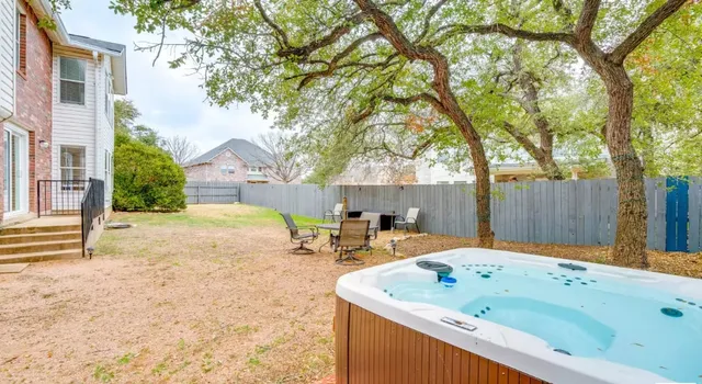 a backyard of a house with table and chairs