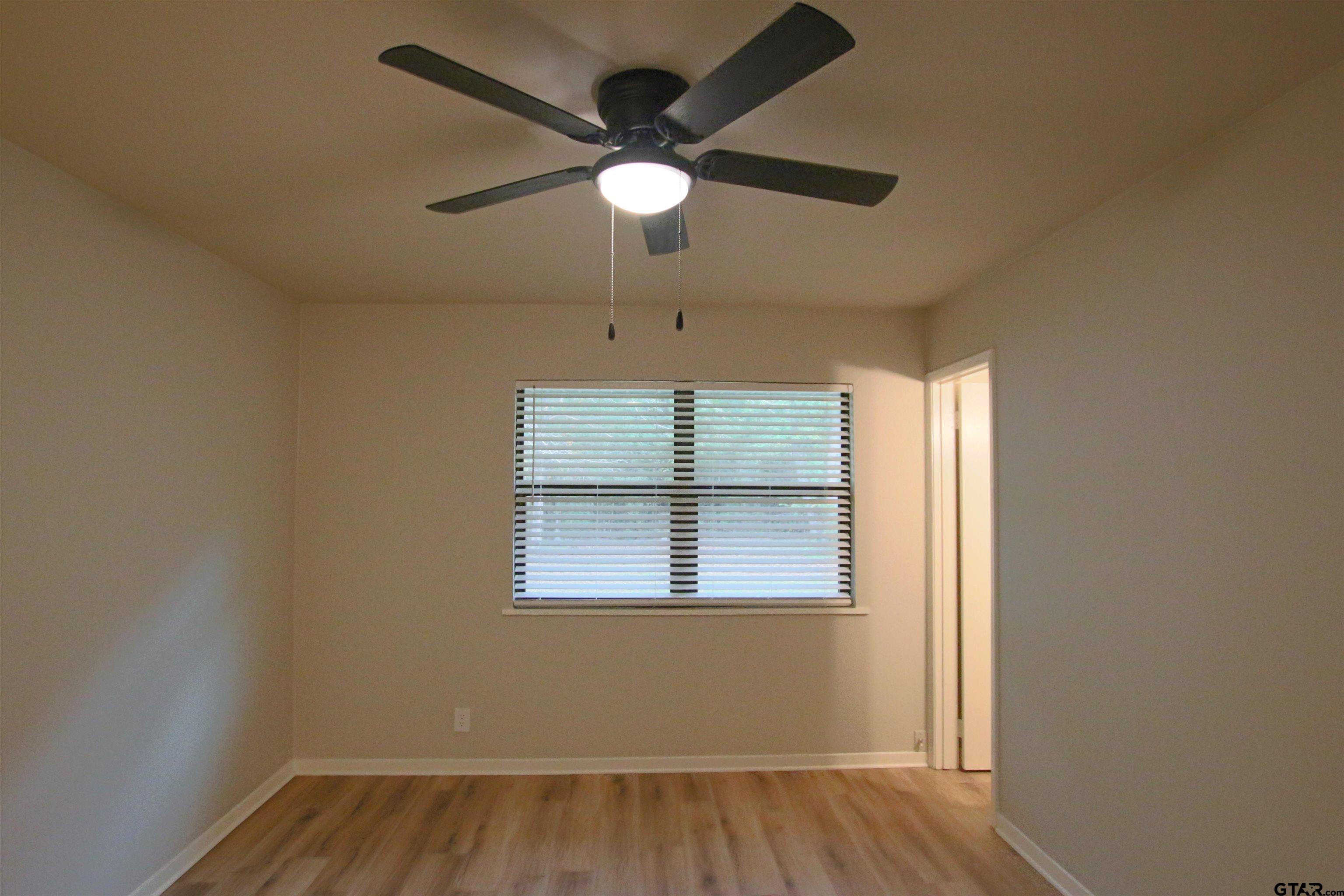 12336 Chapman Road Tyler, TX 75708 - Photo 11 of 19 an empty room with a window and a ceiling fan