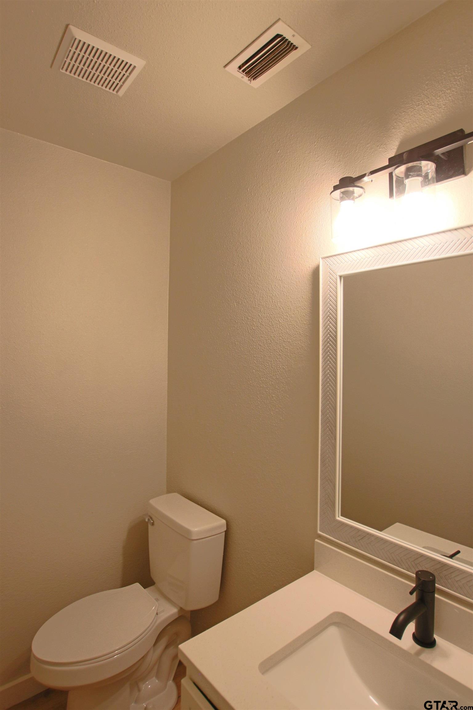 12336 Chapman Road Tyler, TX 75708 - Photo 14 of 19 a bathroom with a sink a toilet and mirror