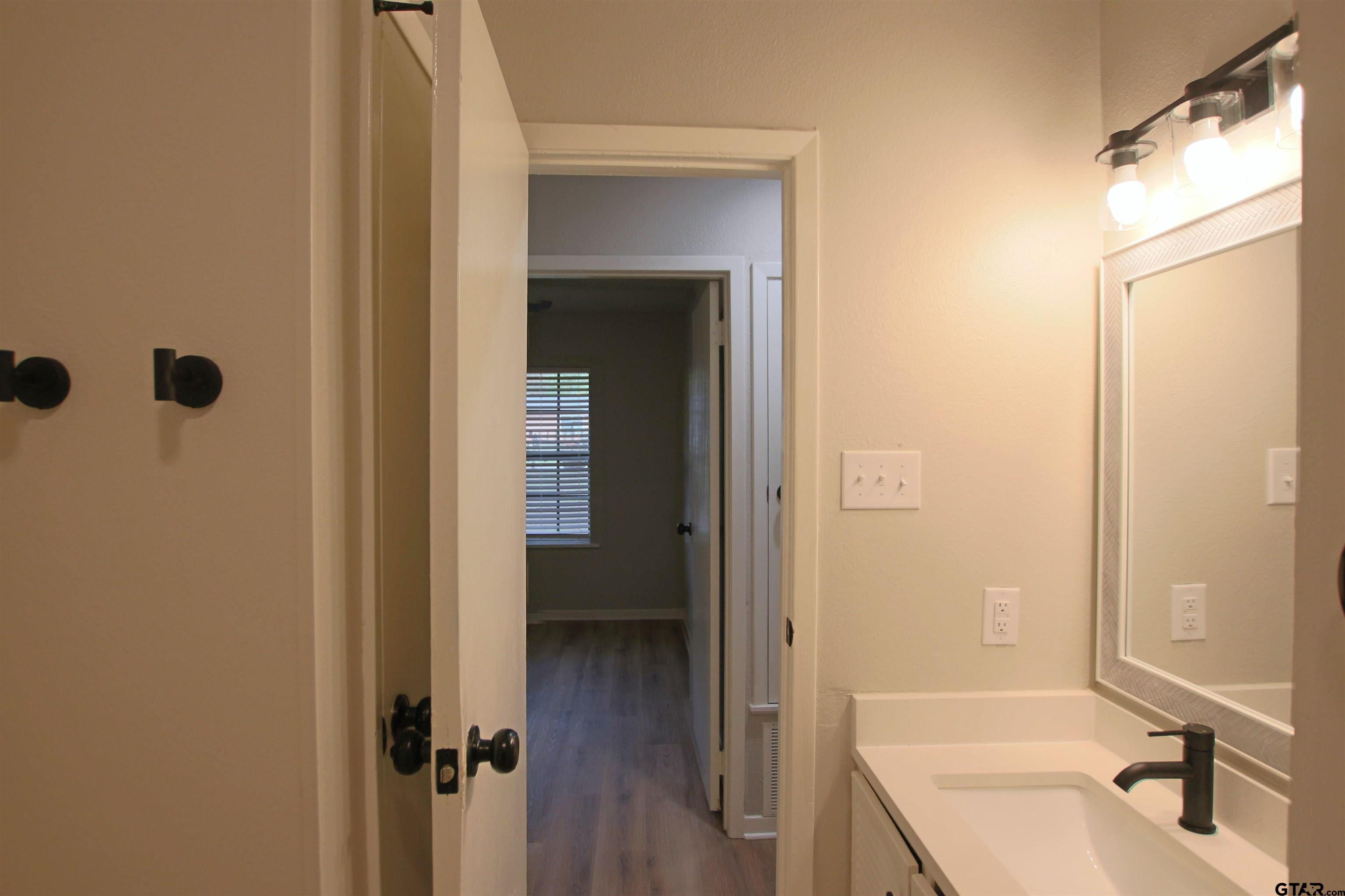 12336 Chapman Road Tyler, TX 75708 - Photo 18 of 19 a bathroom with a sink and a mirror