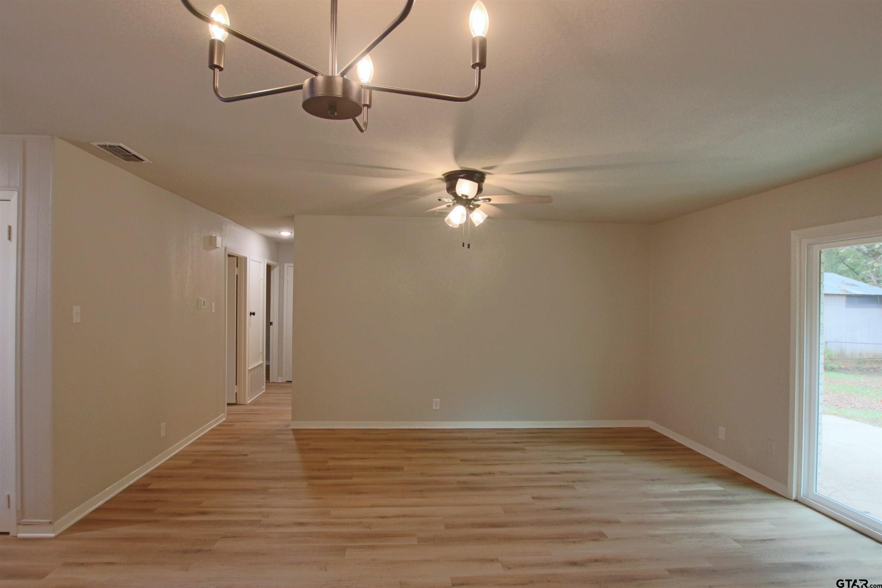 12336 Chapman Road Tyler, TX 75708 - Photo 3 of 19 wooden floor in an empty room with a window