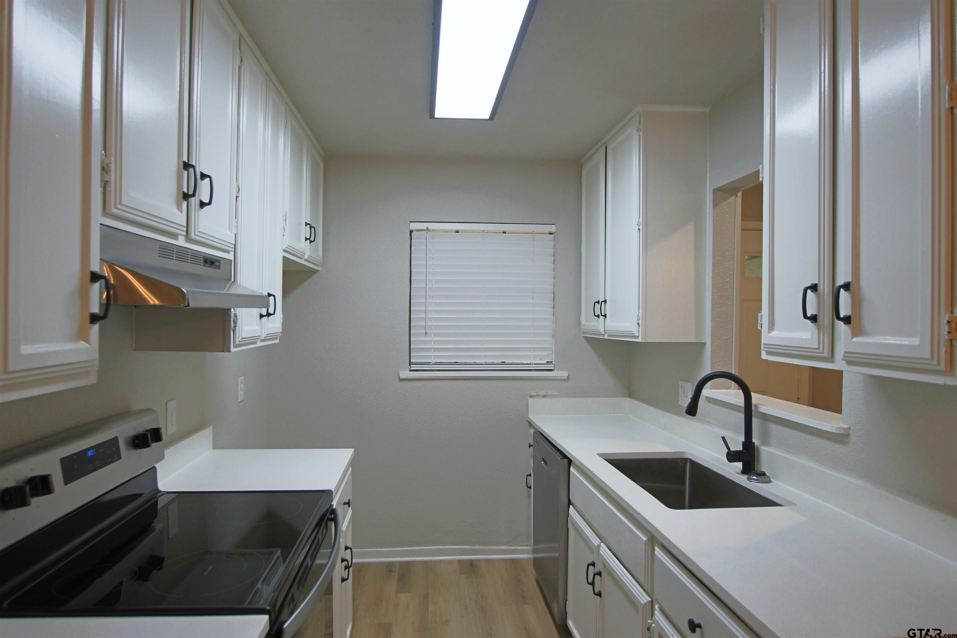 12336 Chapman Road Tyler, TX 75708 - Photo 4 of 19 a view of a kitchen sink and cabinets
