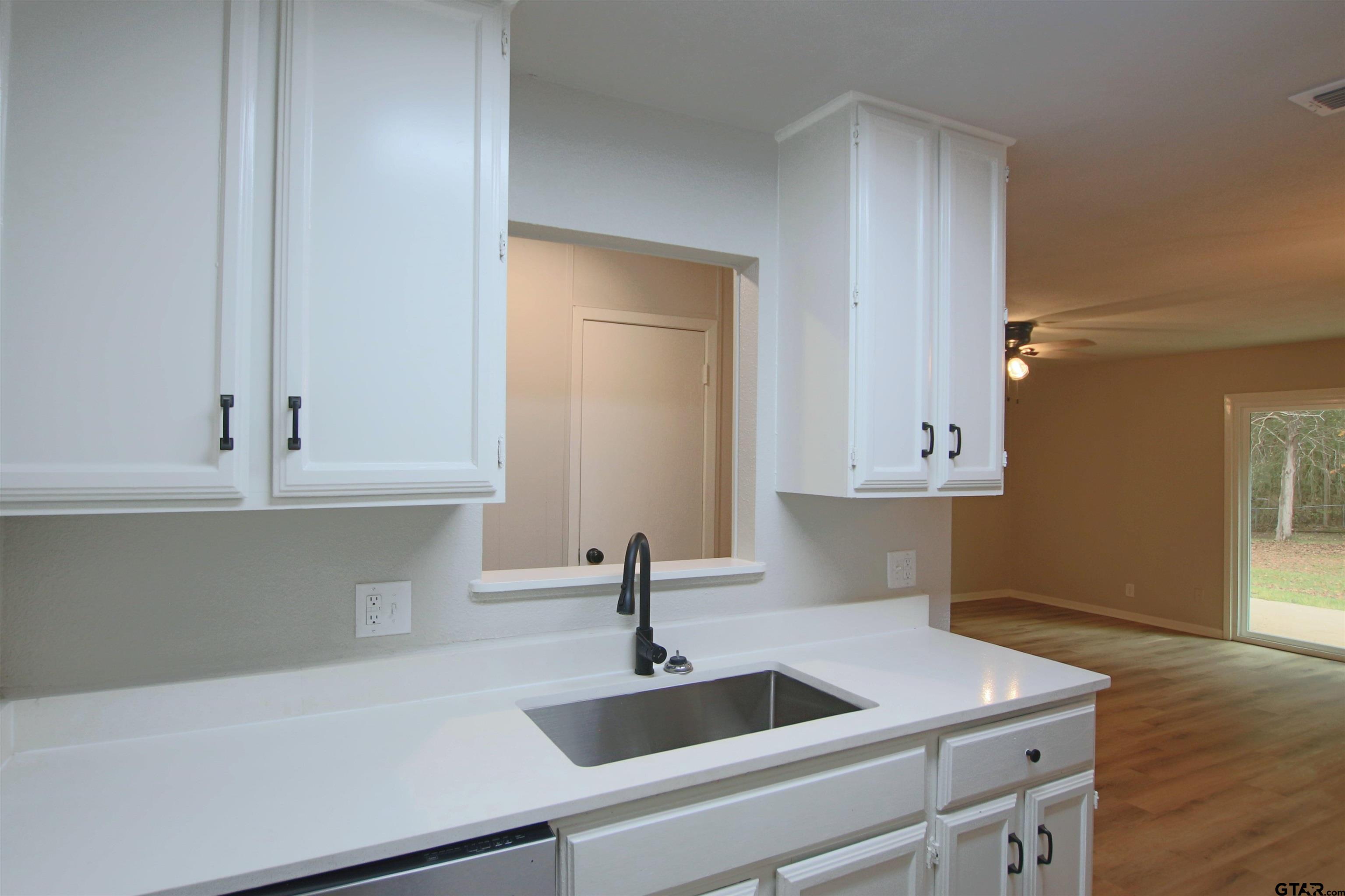 12336 Chapman Road Tyler, TX 75708 - Photo 6 of 19 a kitchen with a sink and cabinets