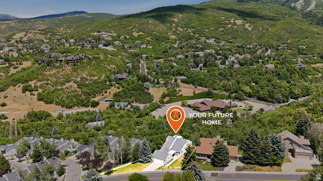 1979 Cave Hollow Way Bountiful, UT 84010 - Photo 54 of 59 Aerial perspective showcasing a property with a multi-level roofline, situated within a verdant, mountainous landscape