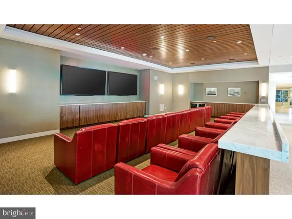 a living room with furniture pool and flat screen tv