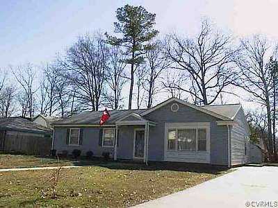 911 Williamsburg Road Colonial Heights, VA 23834 - Photo 1 of 1 a front view of a house with a yard and garage