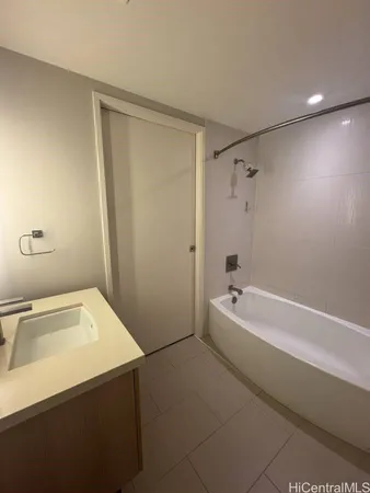 a bathroom with a tub a sink and a shower