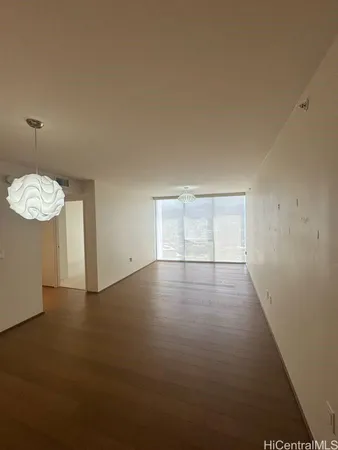 an empty room with windows and fireplace