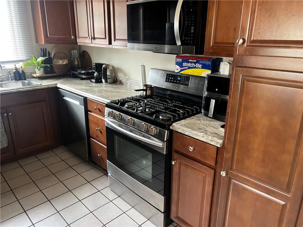 309 Magazine Street Carnegie, PA 15106 - Photo 3 of 18 a kitchen with granite countertop a sink stove and cabinets