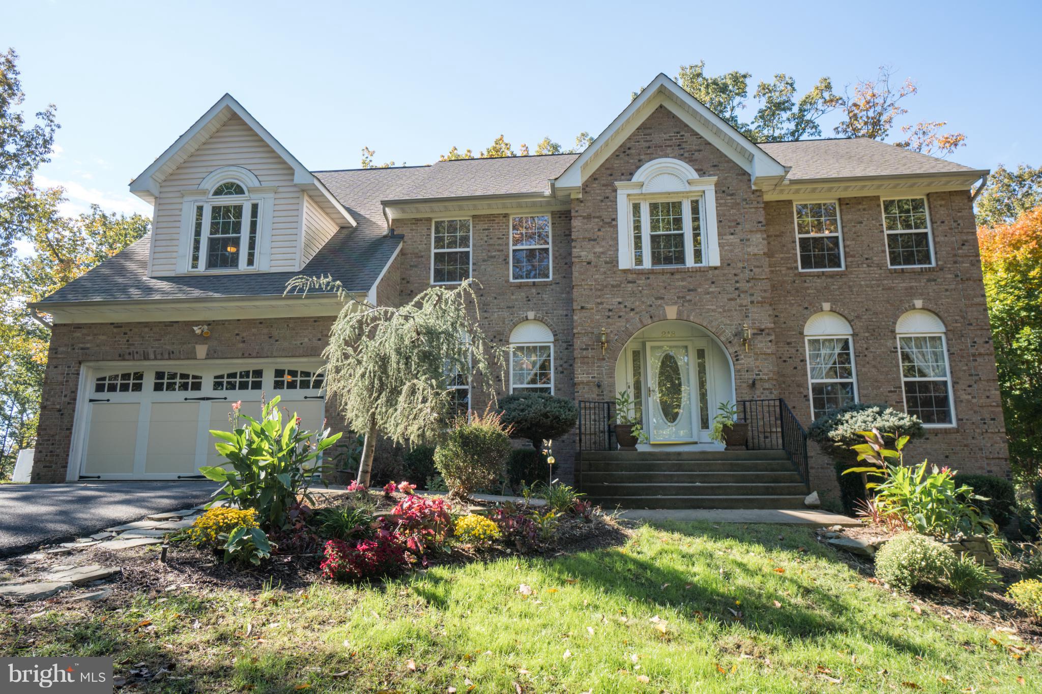 218 Greenbank Road Fredericksburg, VA 22406 - Photo 1 of 20 a front view of a house with a yard