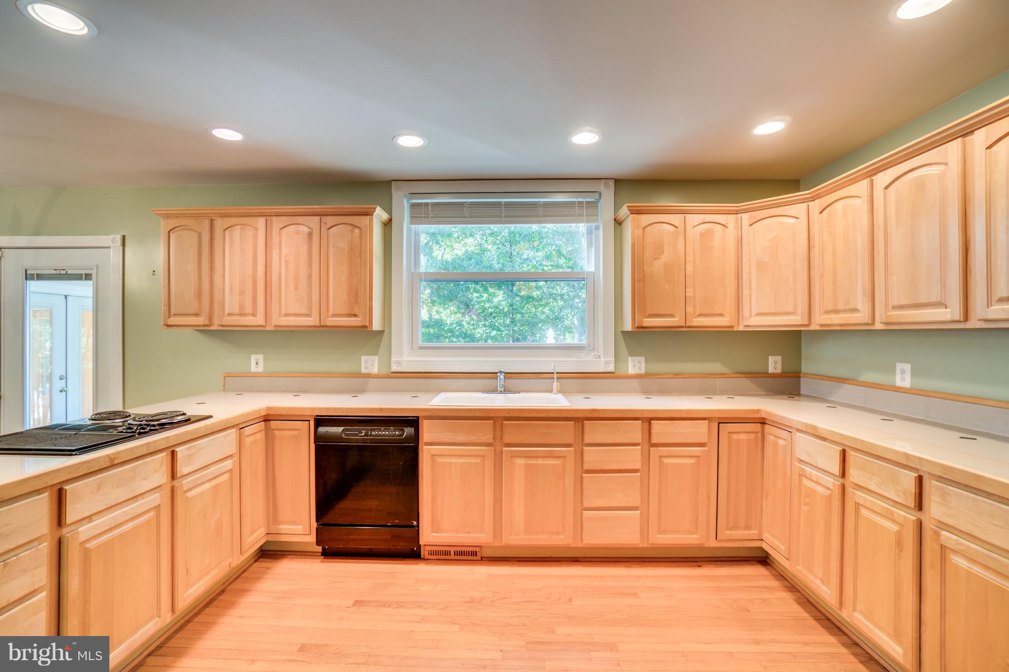218 Greenbank Road Fredericksburg, VA 22406 - Photo 11 of 20 a kitchen with stainless steel appliances granite countertop a stove a sink and a microwave