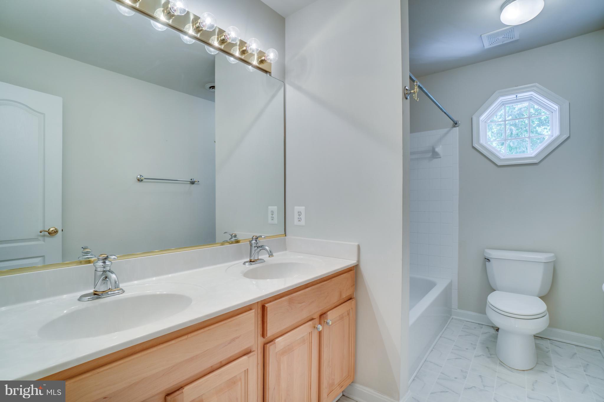 218 Greenbank Road Fredericksburg, VA 22406 - Photo 16 of 20 a bathroom with a toilet a sink and a mirror