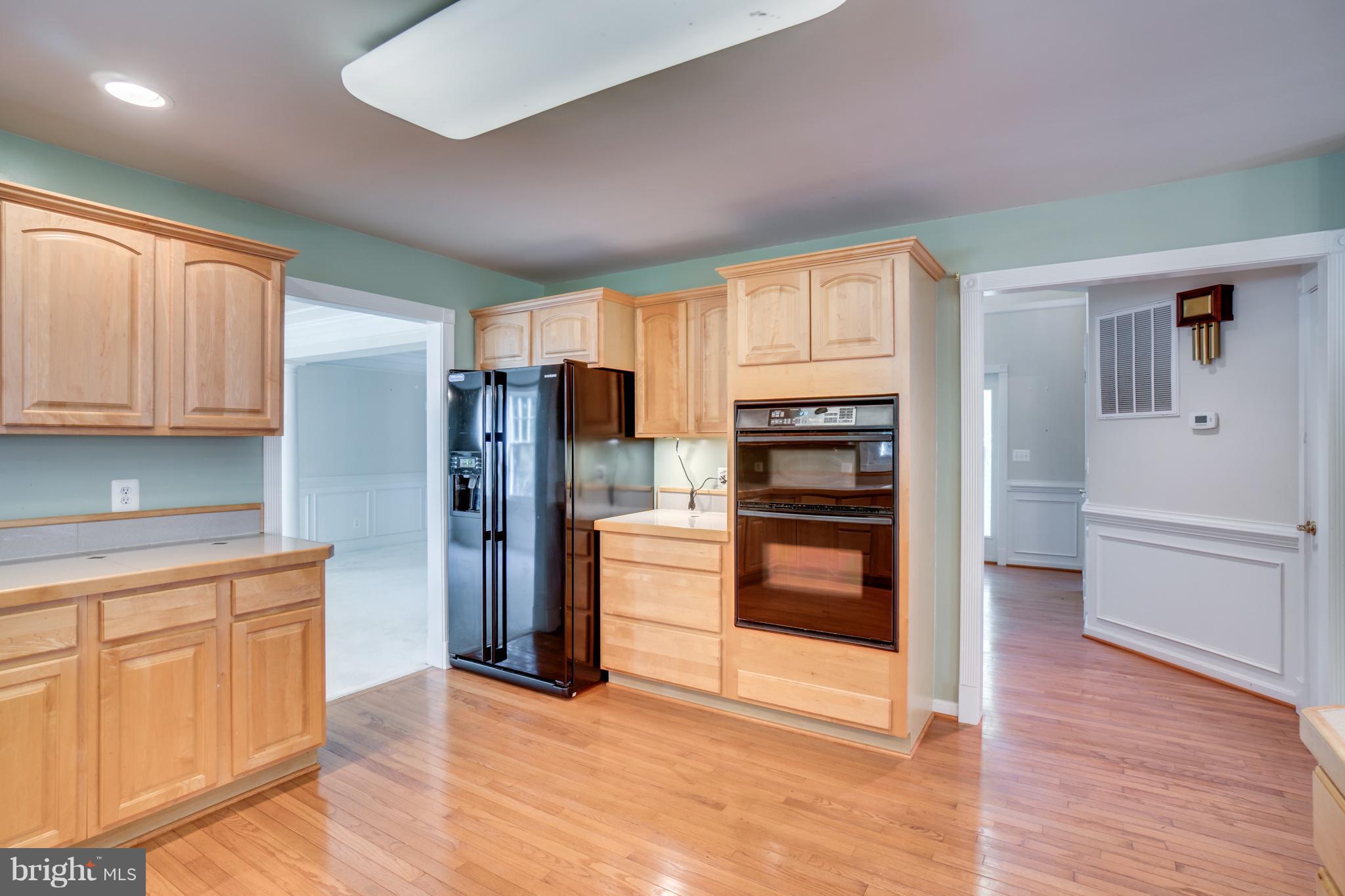 218 Greenbank Road Fredericksburg, VA 22406 - Photo 9 of 20 a kitchen with stainless steel appliances a refrigerator and wooden cabinets